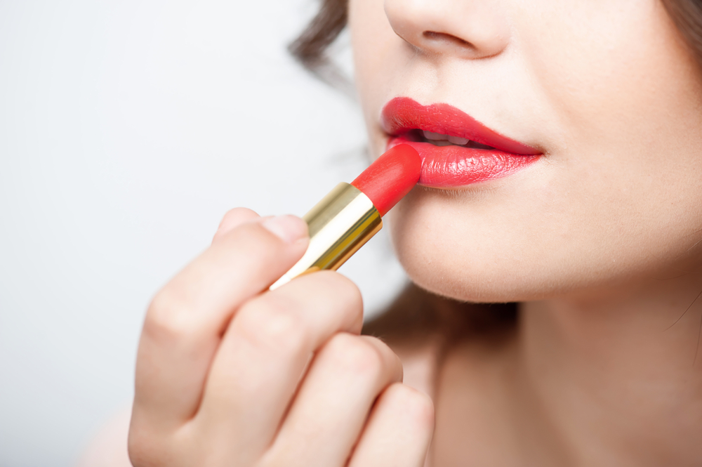 Lady applying red lipstick